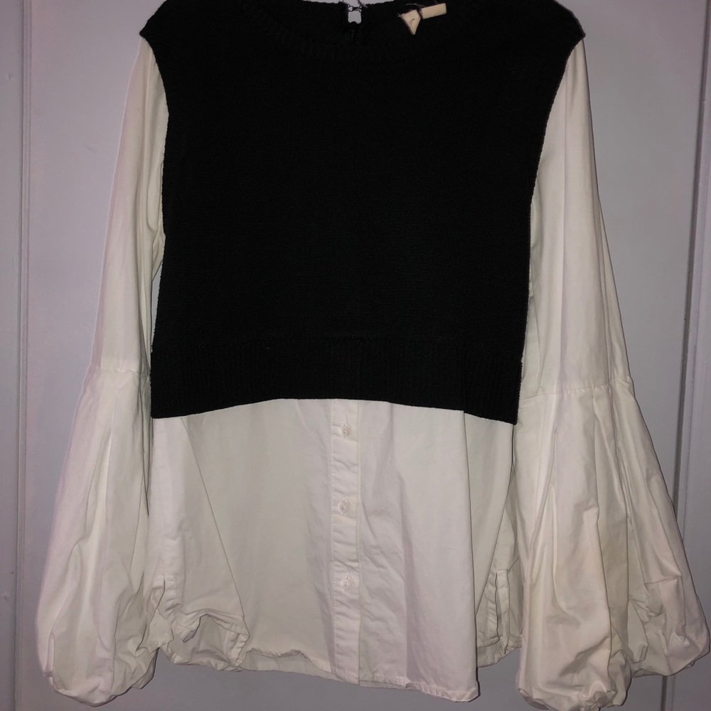 Black sweater attached to white button down.